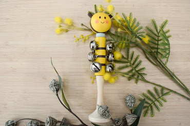 Wooden Bee Bell Stick by Kaper Kidz featuring a bee-shaped wooden handle and a bell for children's musical play.