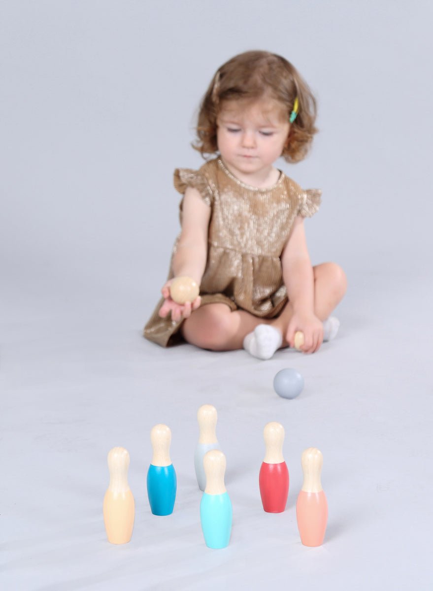 Colorful wooden bowling set by Kaper Kidz with painted pins and ball, designed for childrenβs indoor play and fun.
