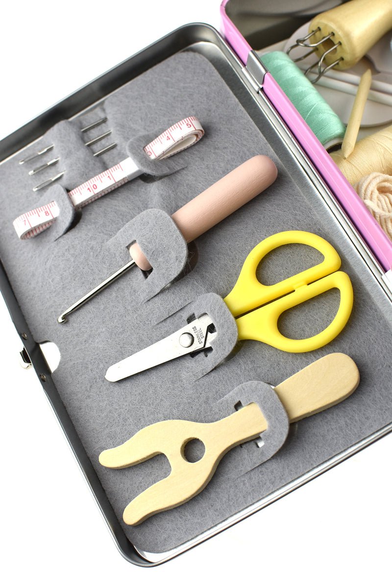 Kaper Kidz Calm & Breezy Knitting Kit in a metal tin case with colorful yarn and knitting needles for beginners.