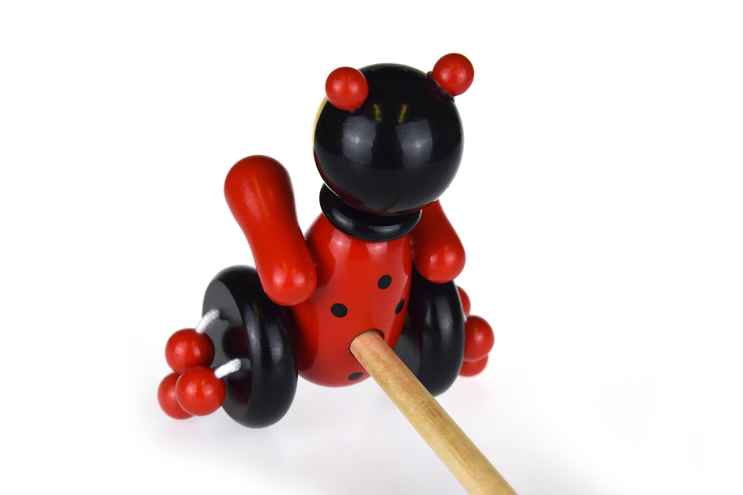 Kaper Kidz wooden ladybird push-along toy with colorful painted spots and sturdy wooden handle for toddlers.
