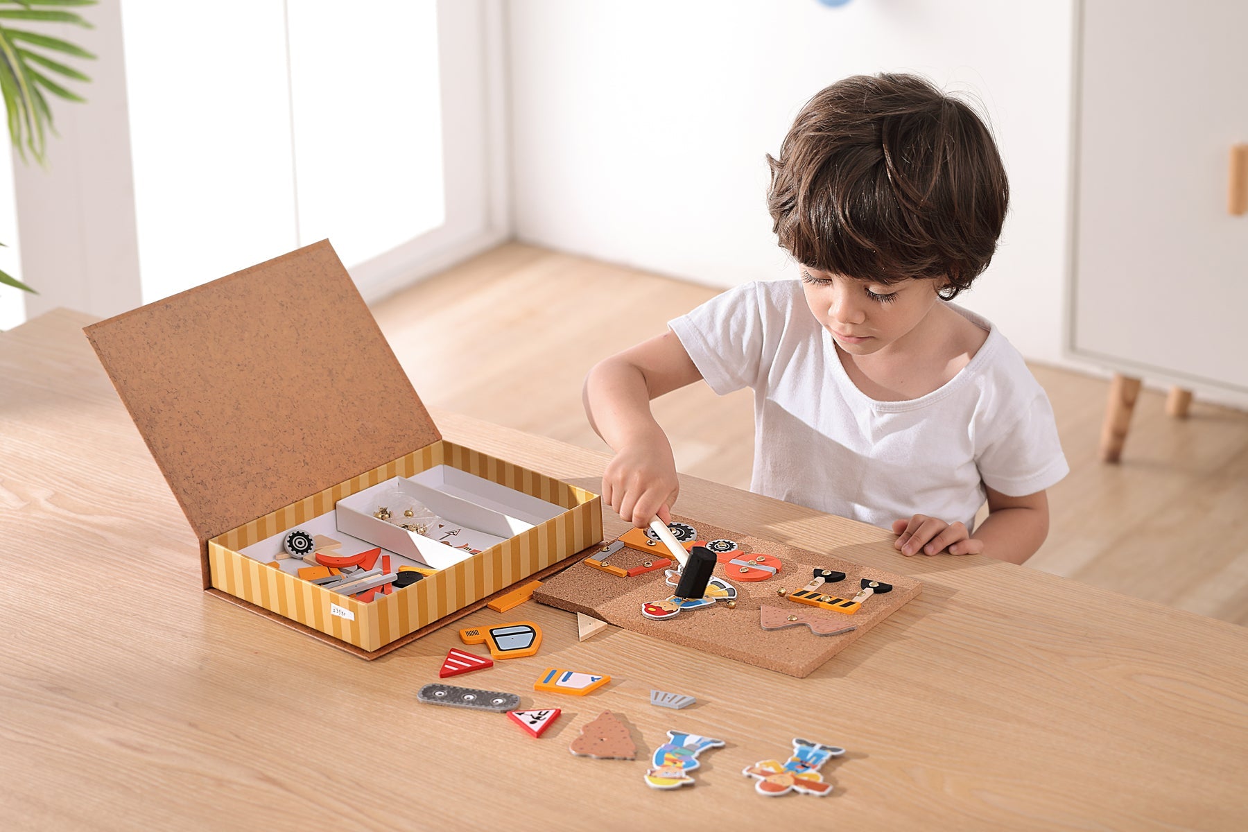 Wooden construction truck tap-a-shape in Kaper Kidz bookcase, educational toy with shape sorting and colorful truck design.