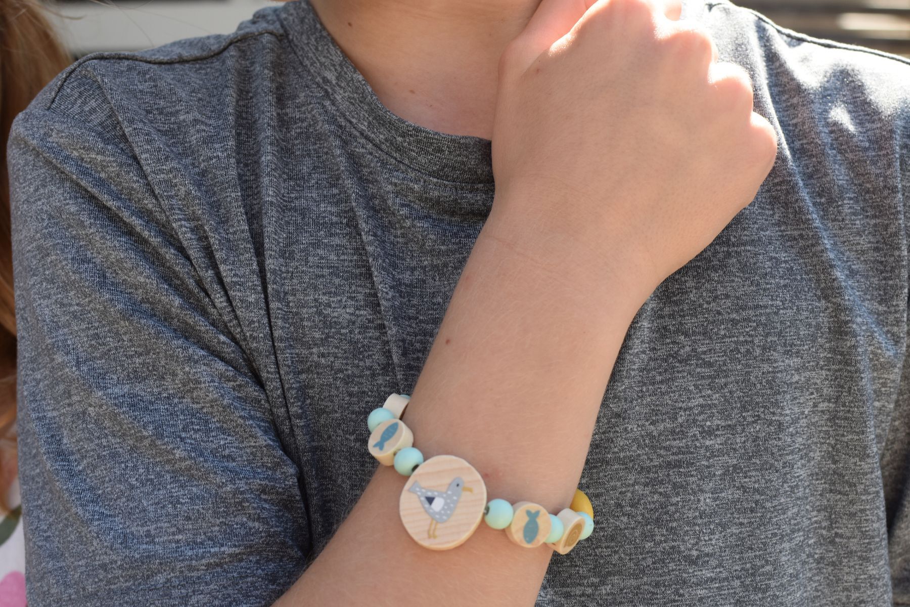 Kaper Kidz DIY wooden bracelet with sea and woodland animal charms, colorful beads, and adjustable strap for kids.