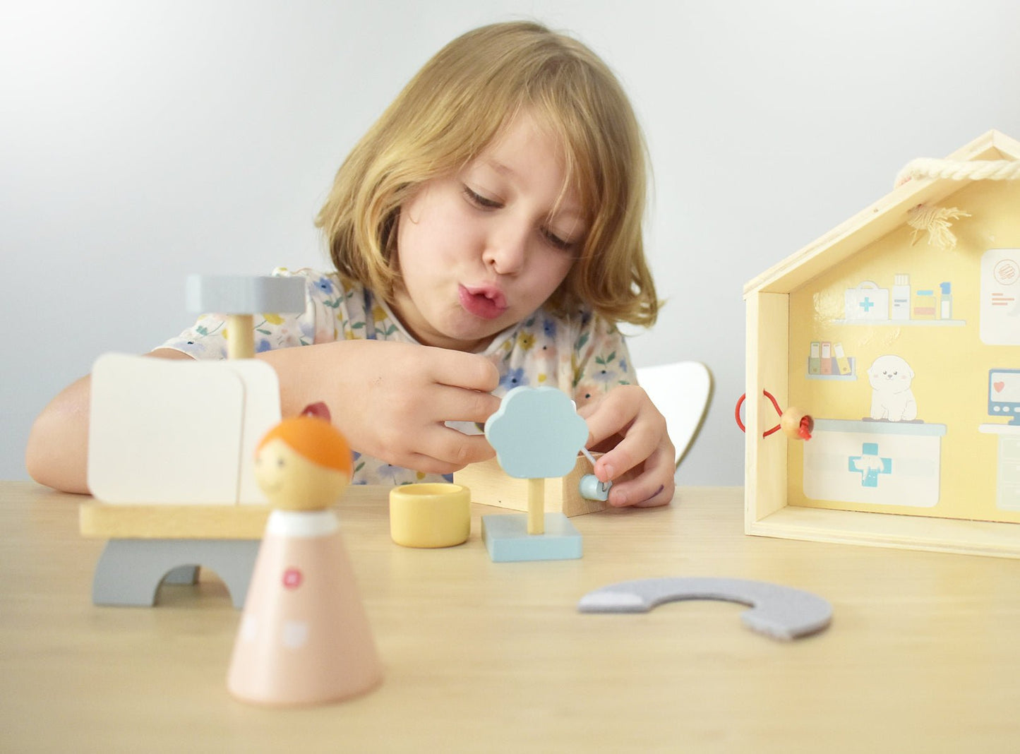 Wooden portable veterinary pet hospital playset by Kaper Kidz featuring toy medical tools and animal figures for imaginative play.