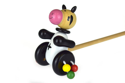 Wooden push-along cow toy by Kaper Kidz, featuring a natural wood finish and colorful details for young children.