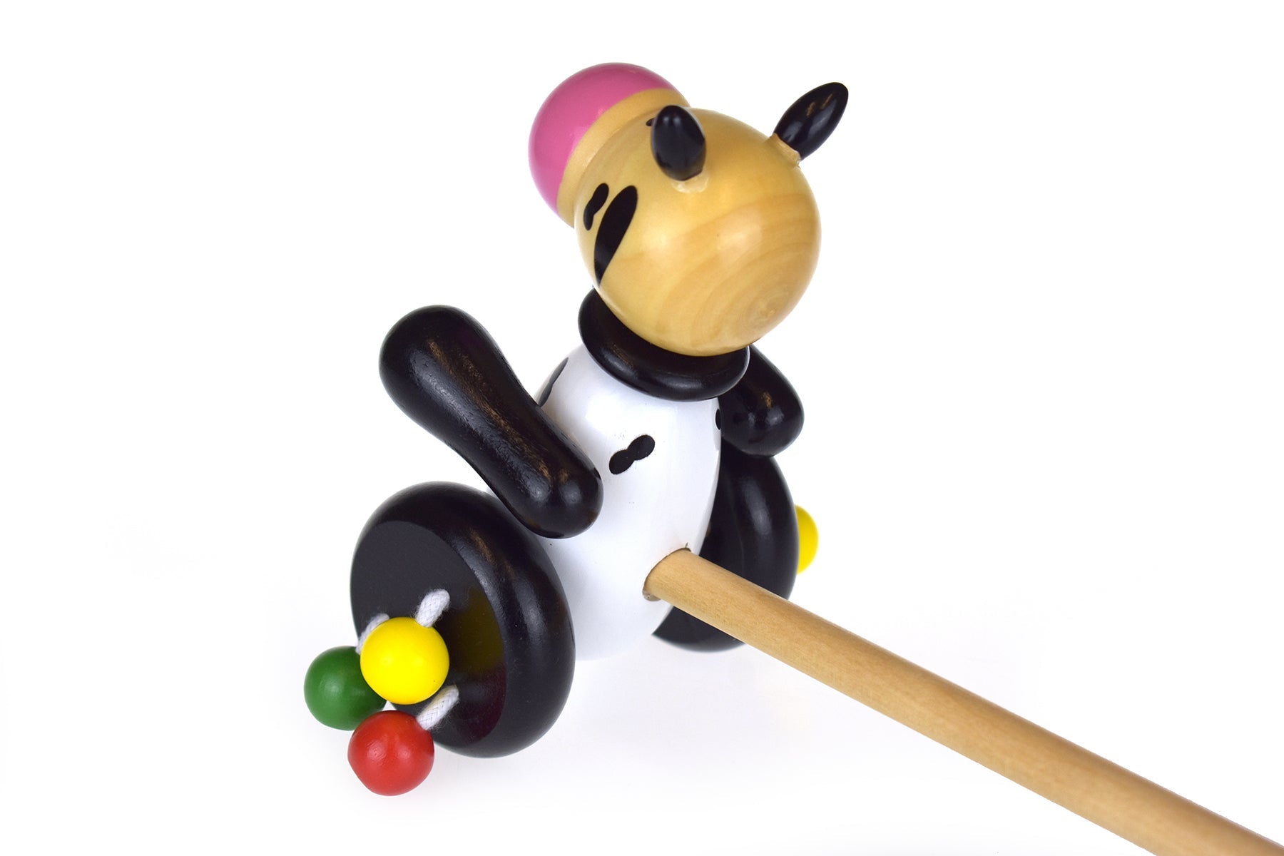 Kaper Kidz push along wooden cow toy with painted details and wooden wheels for young children to pull and play.