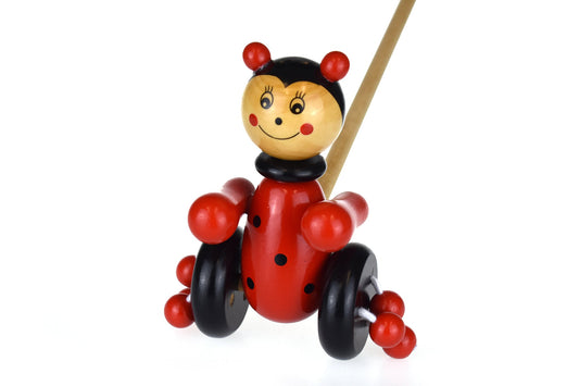 Wooden push-along ladybird toy by Kaper Kidz, featuring colorful painted details and a sturdy handle for young children.