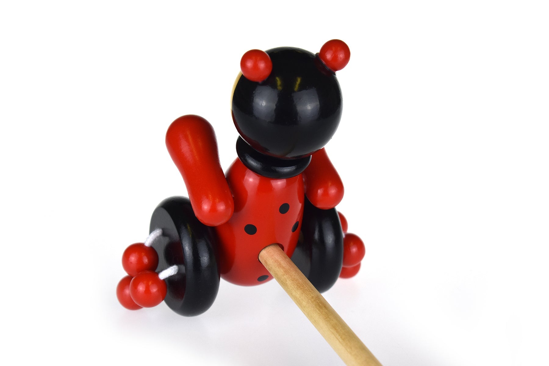 Kaper Kidz wooden ladybird push-along toy with colorful painted spots and sturdy wooden handle for toddlers.
