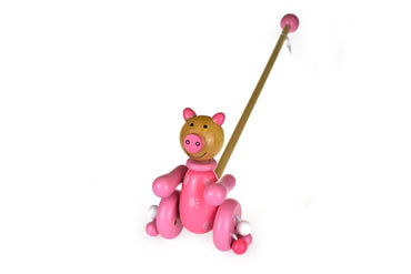 Kaper Kidz push-along wooden pig toy for young children, featuring a cute pig design and smooth wooden surface.