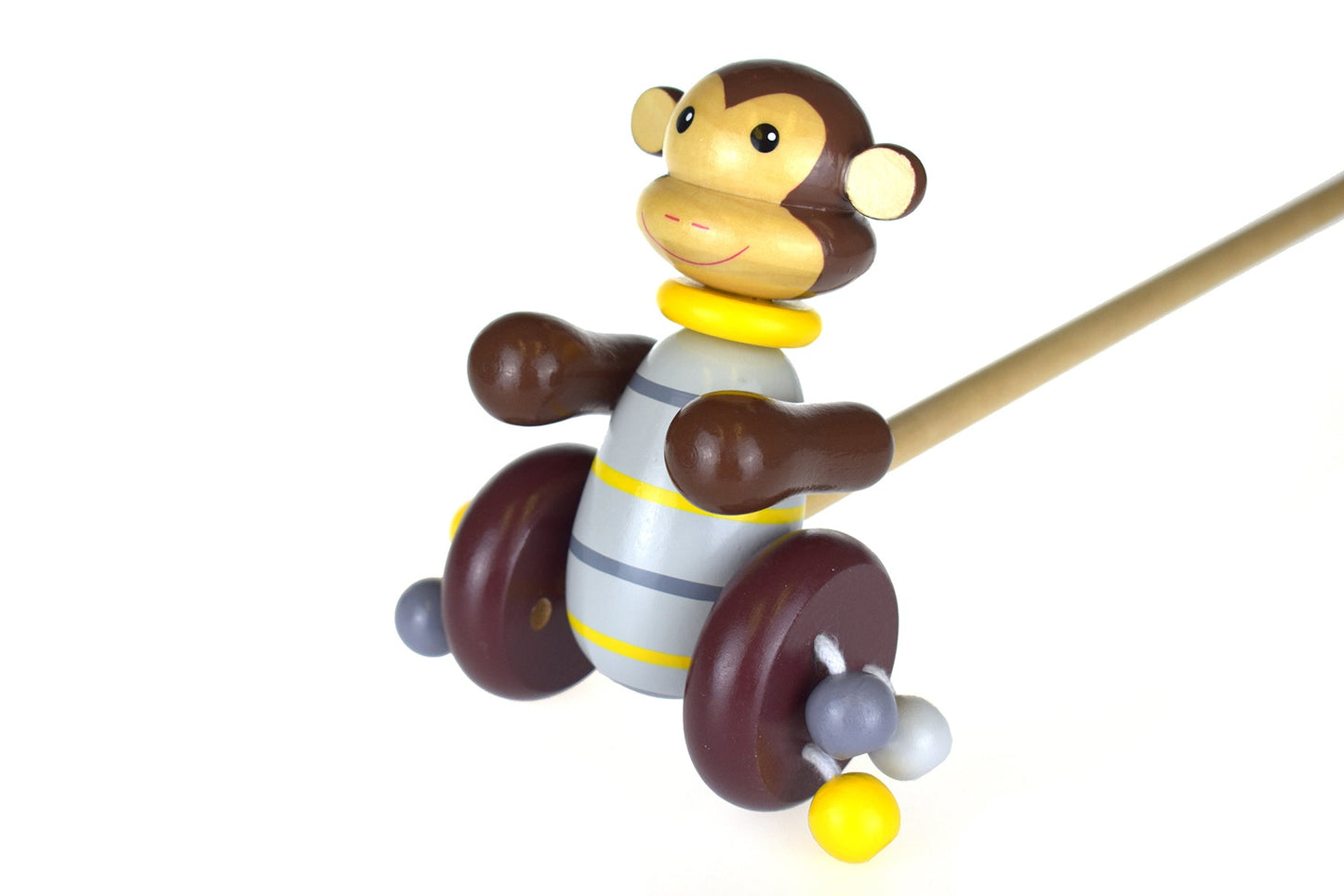 Kaper Kidz Push-a-Long Monkey toy, a colorful plush stuffed animal with a wooden pull string for toddlers to carry and play.